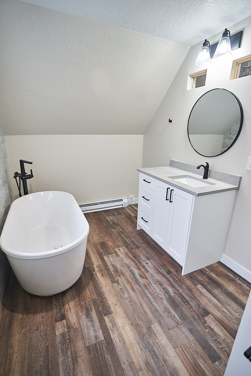 ADU build: Completed ADU bathroom with standalone tub and white vanity (Photo 1/18)