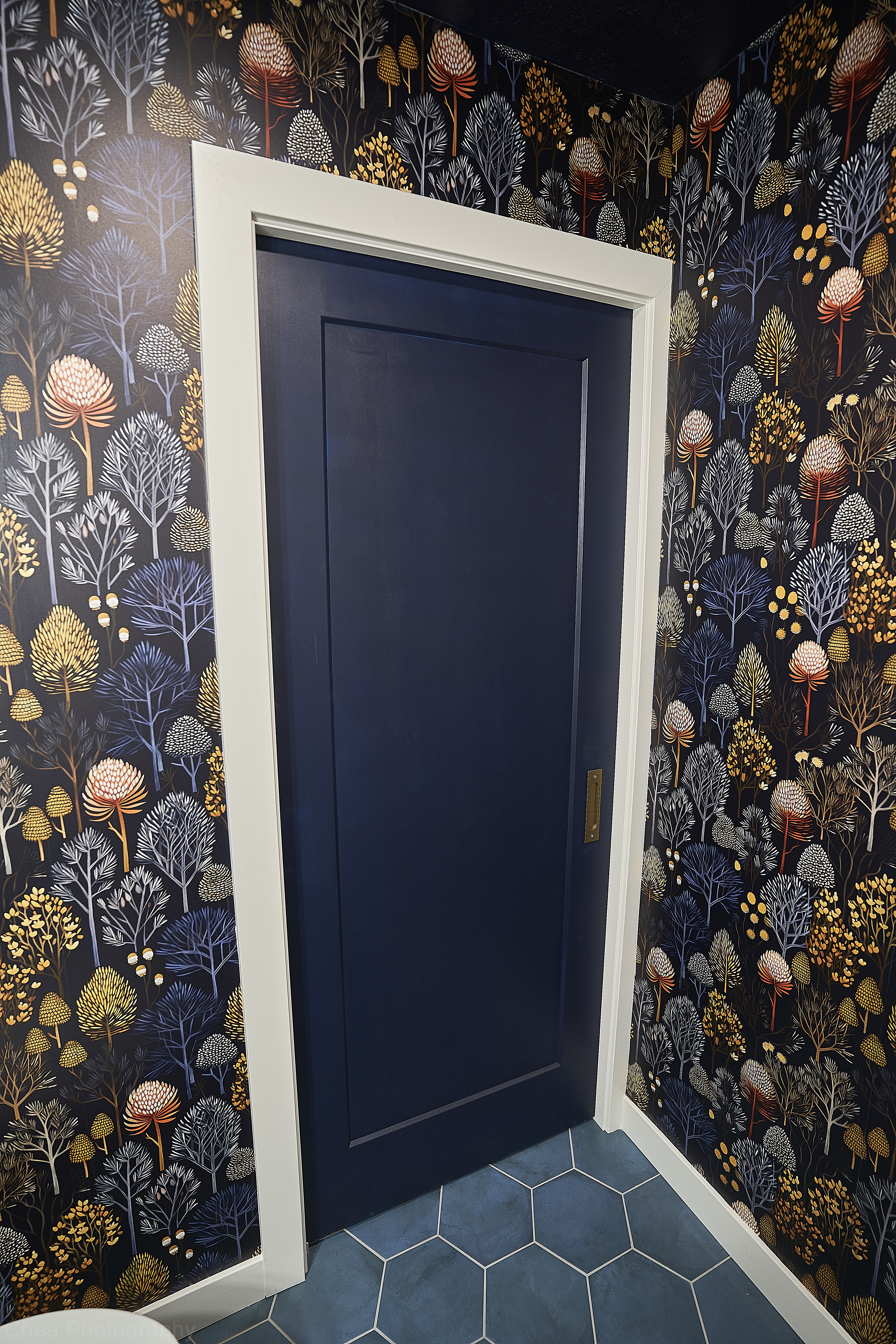 Suite project: Completed suite featuring bold floral wallpaper and a blue pocket door (Photo 1/22)