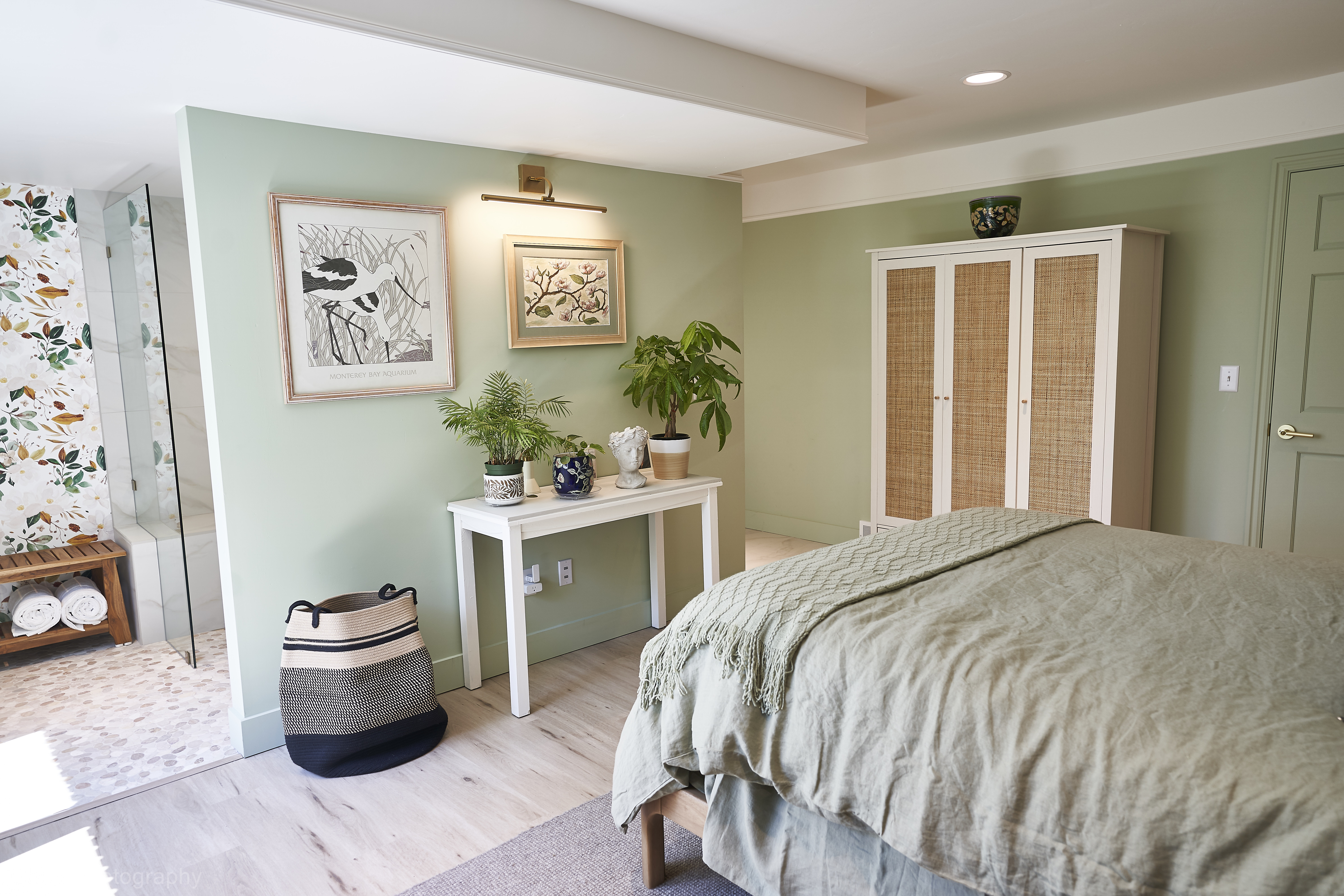 Suite project: Completed suite bedroom area with sage green walls and woven wardrobe (Photo 10/22)