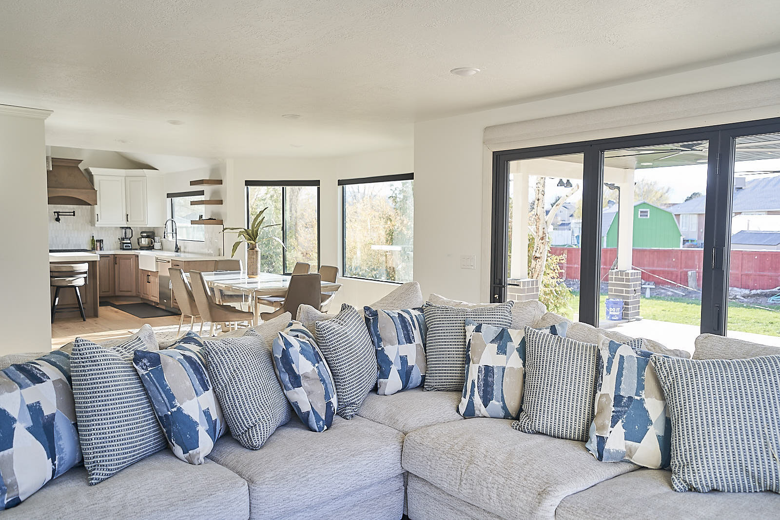South Jordan project: Comfortable living room with large grey sectional sofa and patterned pillows (Photo 12/29)
