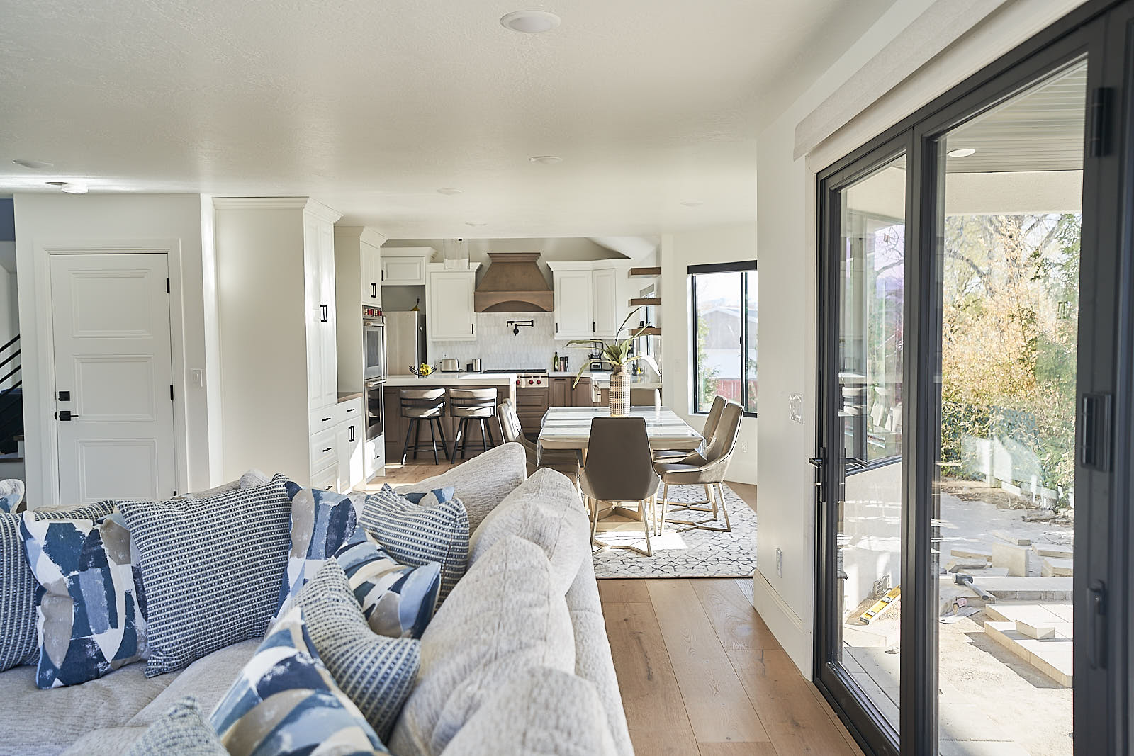South Jordan project: Living room with large sliding glass doors leading to the exterior (Photo 13/29)