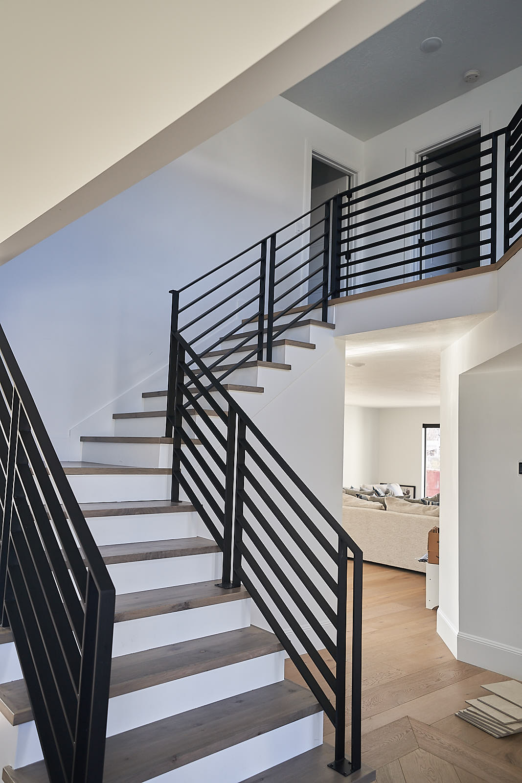 South Jordan project: Detail of the custom metal staircase railing and open floor plan (Photo 15/29)