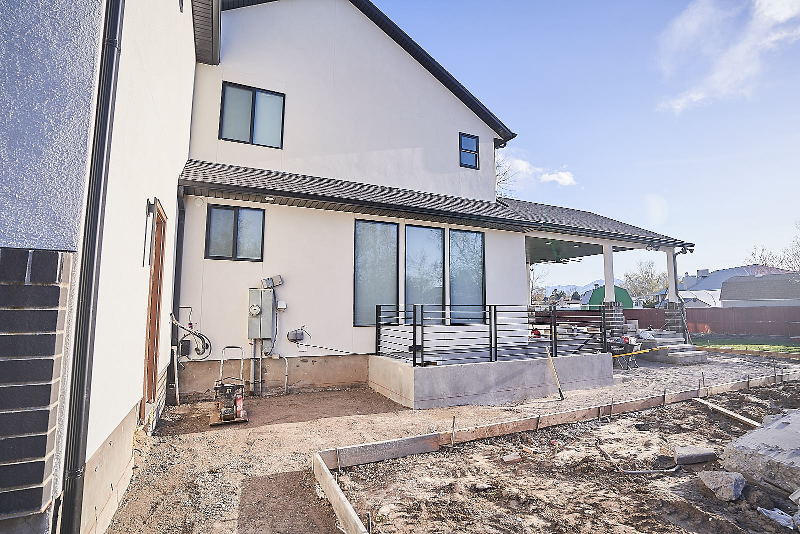South Jordan project: Rear exterior progress showing the new addition and concrete foundation for the patio (Photo 28/29)